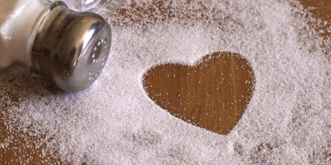 A salt shaker spilled out into a heart shape