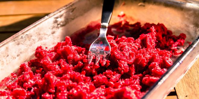 frozen raspberry being mashed and broken up